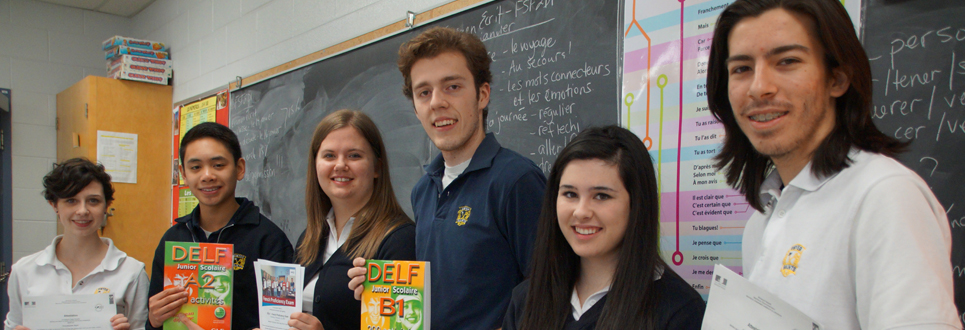 Students holding DELF French Proficiency books in a classroom