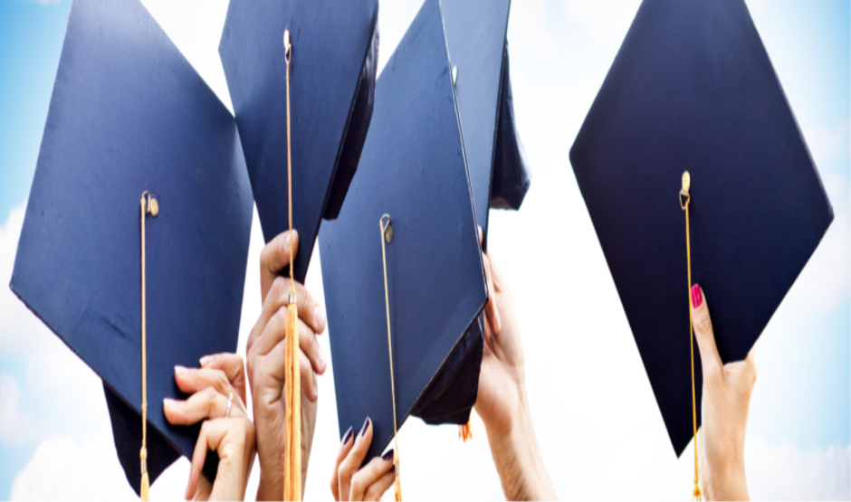 Graduation caps in student hands